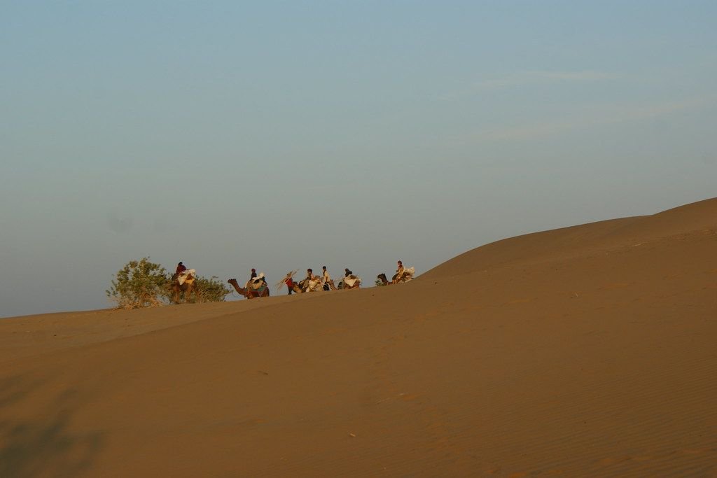 Camel caravan crossing the dunes near Jaisalmer